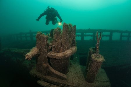 A scuba diver explores an old, wooden shipwreck in Lake Michigan. 